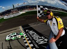 Kyle Busch, driver of the No. 18 Interstate Batteries Toyota, takes the checkered flag as he crosses the finish line to win the NASCAR Sprint Cup Series Pure Michigan 400 at Michigan International Speedway on Aug. 21 in Brooklyn, Mich. Credit: Jared C. Tilton/Getty Images for NASCAR